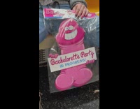 Girl holds pink bachelorette party penis decoration 
