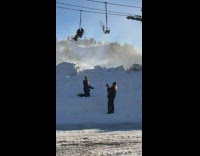 Woman kneel throw snow on air chairlift