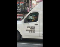 Driver plays yellow maracas while driving in white van, alpine coffee