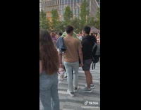 Huge green mucinex costume person dancing in crowd