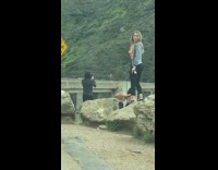 Two girls white tank top hug bridge mountain