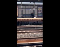 Two men plays instrument at train station part 1