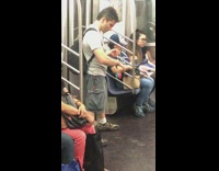 Guy plays with red blue yoyo on subway train