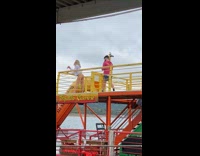 Woman Poses for Photo in Bikini Bottom on Top of Boat
