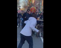 Guy Dances to Street Music with Ball on Head 