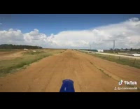 Guy blue dirt bike black gloves hill 