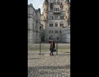 Woman poses in front of castle 