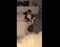 Guy jumps on bed and wakes up sleeping little kid