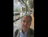 Masked man carrying speakers pass by selfie