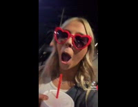 Heart sunglasses girl films cop behind her 