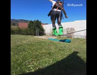 Guy walks across slackline green ski boots 