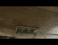 Rain water runs across parking garage ceiling  