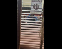 Guy dances next to restaurant with pants down 