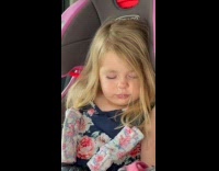 Little girl sleeps with snot and wipes it on her face inside the car