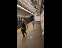 Man in black runs away from Chucky and guy in mask 
