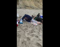Two women doing flexible yoga poses at beach