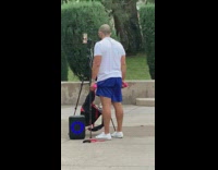 Man white shirt exercise dumbbells tripod park