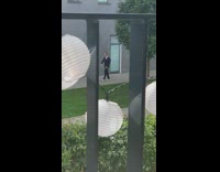 Black suit white shoes guy walks sidewalk 