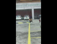 Guy yellow shirt sit parking lot tote