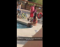 Red bathing suit lady sits 
by pool