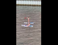 Girl stand floating board red oar river