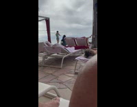 Girl hold two plushies together at beach