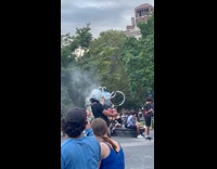 Two guys smoke with head inside gallon