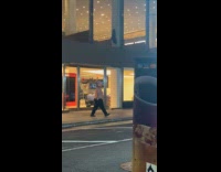 Shirtless man walks around wear majinbuu mask