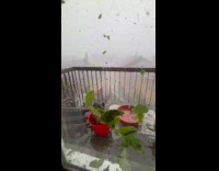 Man films the storm with neighbor outside