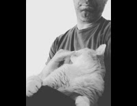Black white filter guy pets his cat