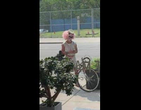 Guy with face paint wears pink wig 