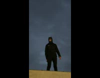 Guy doing batman impression on rooftop