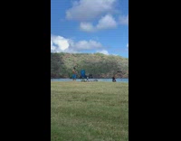 Woman remove vest show striped swimsuit underneath