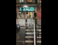 Guy hits punching bag hanging on light