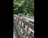 Woman yellow top jeans pose on the road bridge