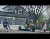 Family graduation ceremony neighborhood street blue gown 