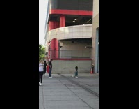 Little girl practices her gold swing in front of a building garage with her dad