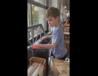 Boy gets his food from a train 