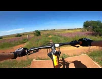 POV of guy biking on dirt track falls when landing