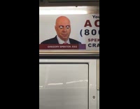 Submitter films googly eyes poster in subway