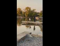 Girl dress hold pole feet touch water