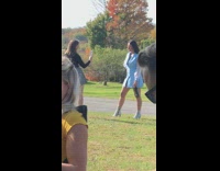 Girl blue coat heels hold wine bottle