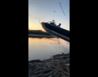 Guy drive speedboat jump through pile of wood