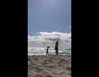 Girl twirls on beach sand