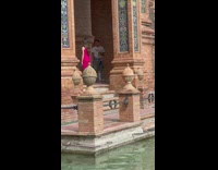 Woman in pink dress models near the river