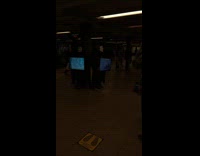 guys dressed in masks with tvs strapped to chest