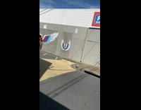 Shirtless guy pose with wings mural car