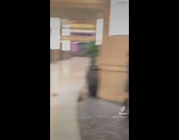 Guy jumps reaches sign batman walks  comes out 