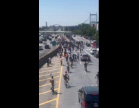 Teenagers on bicycle rides and overtakes Triborough Bridge