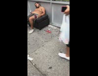 Shirtless guy passed out and sleeps on black couch with pepsi bottle in hand